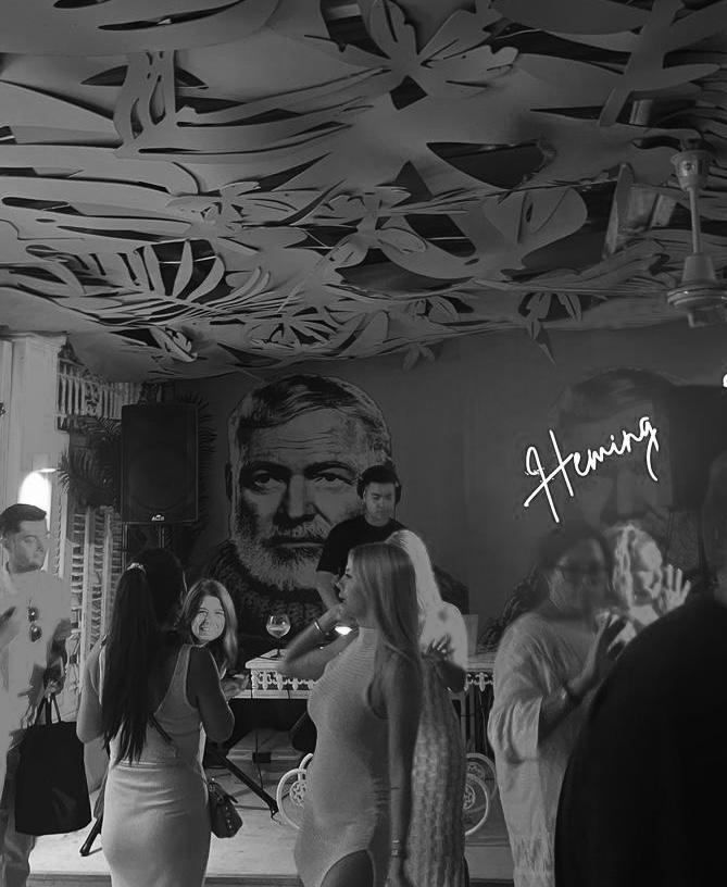 MCL DJing at Hemingway's, crowd beneath the leaf-cut ceiling
