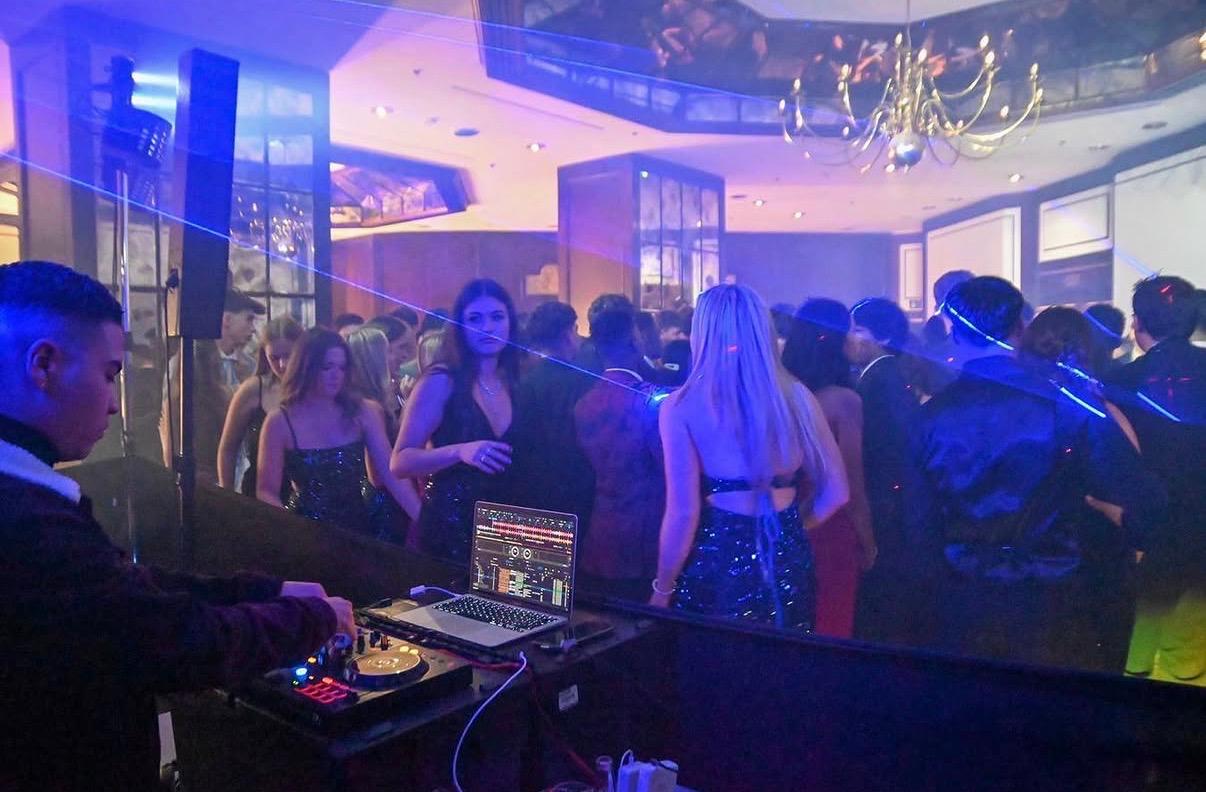 MCL on the decks with lasers over a packed dance floor
